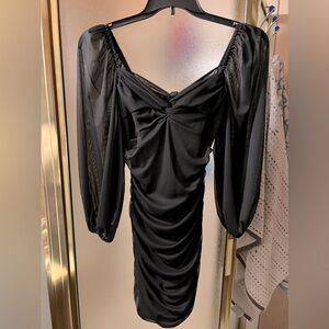 Classic black dress/ sheer sleeves.